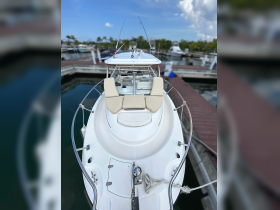 A top-down view of the helm area on a boat, showcasing comfortable seating and a well-equipped dashboard, perfect for a day on the water.