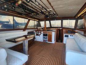 The interior of a well-equipped boat featuring a spacious helm and comfortable seating, ideal for fishing trips or leisurely cruises.