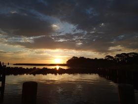 A stunning sunset over the harbor, reflecting beautifully on the water — a perfect backdrop for evening boat trips and relaxation.