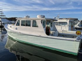 A clear side view of a docked boat, showcasing its sleek design and structure, perfect for boating enthusiasts and potential charters.