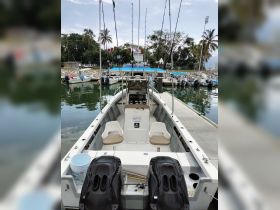 Interior view of a fishing boat showcasing the helm and seating area, ideal for anglers looking for a comfortable fishing experience.