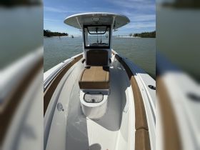 Interior view of a sleek boat helm featuring comfortable seating and a modern console, perfect for a day on the water.