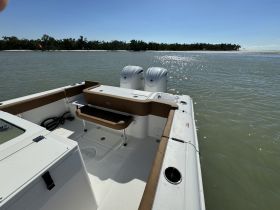 Interior view of a boat showcasing the seating and helm area, perfect for fishing or leisure outings on the water.