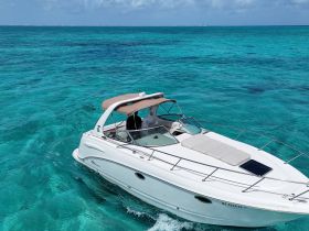 A stunning aerial view of a sleek speedboat cruising through crystal-clear turquoise waters, perfect for a day of adventure on the open sea.