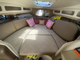 Cozy interior seating area of a boat, featuring comfortable cushions and ample space for relaxation — perfect for enjoying time on the water.