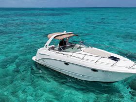A sleek speedboat glides through crystal-clear turquoise waters, showcasing the perfect vessel for a day of adventure on the sea.