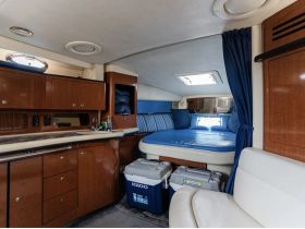 A cozy interior view of a boat cabin featuring comfortable seating and storage, perfect for relaxing during a day on the water.