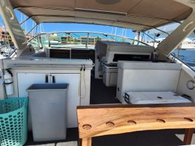 Interior view of a boat's cabin showcasing seating and storage areas, ideal for relaxing and enjoying time on the water.