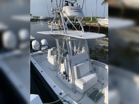 Interior view of a well-equipped fishing boat featuring comfortable seating and a helm, perfect for a day on the water.