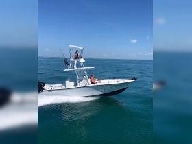 A couple enjoys a thrilling ride on a speedboat, cruising through clear blue waters — perfect for adventure seekers and water enthusiasts.
