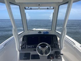 A clean and modern helm view of a Robalo boat, showcasing the console and navigation equipment, perfect for a day on the water.