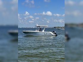A sleek Robalo speedboat cruising through calm waters under a clear blue sky, showcasing the perfect vessel for a day on the water.