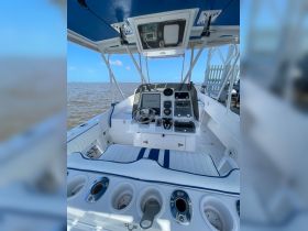 A clean and modern helm area of a boat, showcasing the console and seating, ideal for navigation and comfort while on the water.