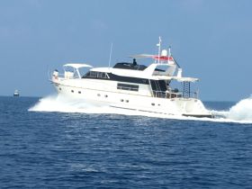 A stunning yacht cruising through clear blue waters, showcasing its elegant design and powerful performance.