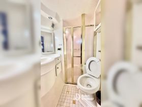 A well-appointed boat bathroom featuring a shower and toilet, showcasing the comfort and convenience of onboard amenities.