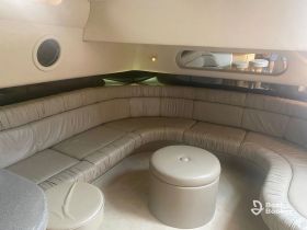 Interior view of a spacious lounge area on a boat, featuring comfortable seating and a stylish design, perfect for relaxing during a day on the water.