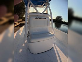 Interior view of a Blazer Bay boat showcasing the seating and helm area, perfect for fishing or leisure outings on the water.