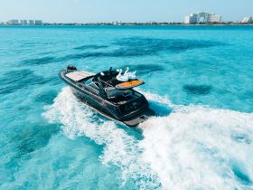 A stunning aerial view of a sleek yacht cruising through crystal-clear turquoise waters, showcasing the perfect vessel for luxury outings and adventures on the sea.