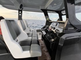 The interior of a sleek offshore boat featuring comfortable seating and a modern helm, perfect for navigating the open waters.