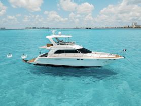 A stunning aerial view of a luxurious yacht cruising through crystal-clear turquoise waters, perfect for upscale boating experiences and island adventures.