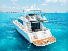 A stunning aerial view of the 'Sea Mami' yacht cruising through crystal-clear waters, showcasing its elegant design and inviting deck space.