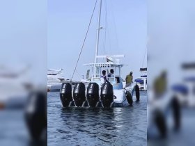 A group of individuals aboard a fishing boat at the dock, showcasing the excitement of a day on the water.