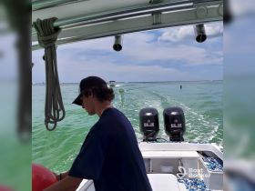 A young man prepares for an exciting day on the water, showcasing the thrill of boating and adventure in a vibrant marine setting.