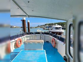 Interior view of a boat's helm area, showcasing seating and storage, perfect for comfortable cruising or fishing trips.