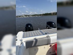 A close-up view of the interior of a boat featuring seating and helm area, showcasing the comfortable design ideal for a day on the water.