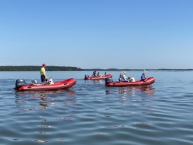 A group of guests enjoys a day on the water in inflatable boats, perfect for exploring scenic waterways and engaging in fun on-water activities.