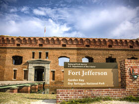 A view of Fort Jefferson at Dry Tortugas National Park, showcasing its historic brick architecture and surrounding landscape.