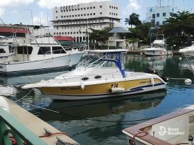 A well-maintained boat named 'DAD'S THERAPY' docked in a marina, surrounded by other vessels, showcasing a serene boating atmosphere.