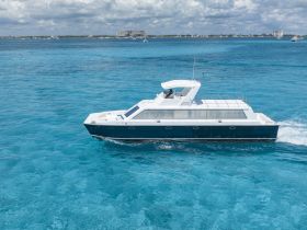 A stunning aerial view of a sleek speedboat cruising through crystal-clear turquoise waters, perfect for luxury charters and island adventures.
