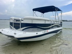 A sleek SouthWind pontoon boat docked in shallow waters, showcasing its stylish design and perfect for leisurely outings on the water.