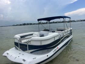 A sleek SouthWind pontoon boat docked in calm waters, perfect for leisurely outings and family gatherings on the water.