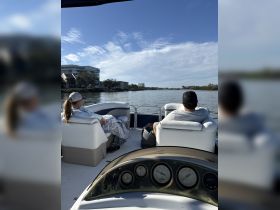 A couple enjoys a relaxing moment on a boat, taking in the scenic waterway views — perfect for unwinding on a sunny day.