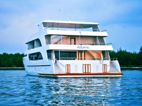 A stunning view of the Adora yacht docked peacefully, showcasing its elegant design and spacious decks, perfect for luxury cruising.
