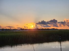A stunning sunset over the coastline, reflecting beautifully on the water — a perfect backdrop for evening boat trips and nature lovers.