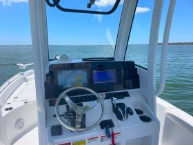 A clear view of the helm and console inside a boat, showcasing the navigation equipment and controls, perfect for boating enthusiasts.