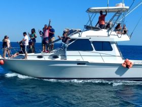 A lively group enjoys a day on the water aboard a boat, celebrating and having fun in the ocean — perfect for memorable outings with friends.