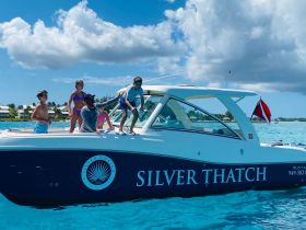 A lively family enjoys their time aboard the Silver Thatch boat, showcasing fun and excitement on the water — perfect for a memorable day of snorkeling and adventure.
