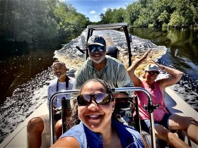 A joyful group enjoys a fun boating adventure, capturing smiles and excitement as they navigate through scenic waterways.