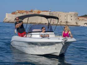 A group enjoys a leisurely boat ride near the historic city of Dubrovnik, showcasing the perfect blend of relaxation and scenic beauty on the water.