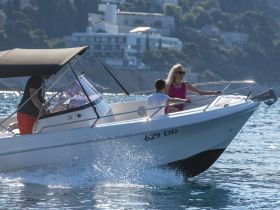 A group enjoys a thrilling ride on a speedboat, showcasing the excitement of on-water adventures in a picturesque setting.
