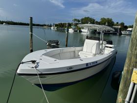 A pristine center console boat docked in calm waters, showcasing its sleek design and ready for a day of adventure on the water.