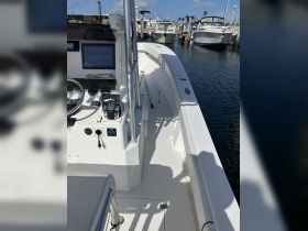 A clean and modern helm area of a boat, showcasing the console and seating, perfect for navigating the waters.