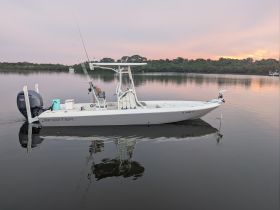 A sleek Skeeter speedboat docked on calm waters, reflecting the serene surroundings — ideal for fishing or leisurely cruises.