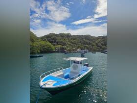 A vibrant speedboat docked in a serene bay, surrounded by lush greenery and other boats — perfect for exploring coastal waters.