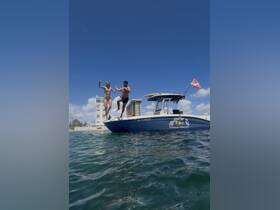 Two excited individuals jump off a boat into the water, capturing the thrill of adventure and fun in the sun — perfect for summer outings and water sports.