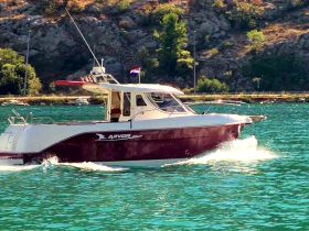 A sleek speedboat glides through clear turquoise waters, showcasing its elegant design and perfect for thrilling adventures on the sea.